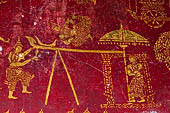 Luang Prabang, Laos - Wat Pa Phai the 'Bamboo Forest Monastery'. Inside gilded stencils against a red lacquered background depict scenes from the Buddhist hell.